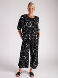Black Circle Print Roundneck Top with Stepped Hemline